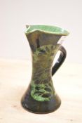 A small early 20th-century William Baron of Barnstaple pottery ware jug, of a distinctive hour gl