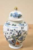 A decorative late 20th-century Chinese porcelain ginger jar, featuring a gilt finial, lidded rim,
