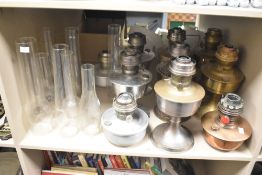 A collection of nine 20th-century Aladdin mantle oil lamps of varying metals, sold together with a