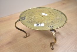 A 20th-century Morecambe HEC Arts and Crafts brass trivet, featuring an Art Nouveau decorative
