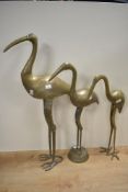 A selection of three 20th-century brass crane sculptures, each featuring long slender necks and
