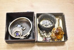 A small collection of costume jewellery, including statement brooches, a large white metal hinged