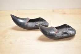 A pair of early 20th-century leather Jutti-style children's shoes, distinguishable by their distinct