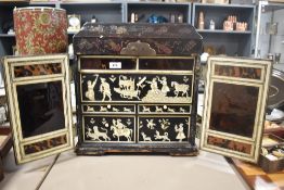 A 19th/20th-century Eastern Indo Persian black lacquered tabletop cabinet, featuring elaborately