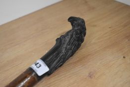 A Hazel walking stick measuring 125cm long with a cast metal top depicting a Parrot