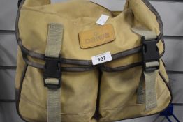 A Daiwa canvas and leather fishing bag which has a removable liner with some lures line and other