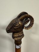 A Three section screw together walking stick with a cast sheeps head handle and a brass ferrule to