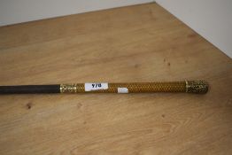 A very intricate riding crop with guilt metal and a date of 1872