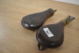 A Leather and brass shot flask and an embossed copper and brass powder flask