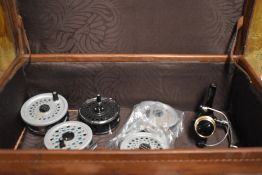 Four fly reels made by beaulite and rimfly with a spare spool and one spinning reel made by