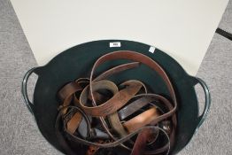 A selection of leather straps, belts including a 4-10 cartridge belt and a revolver case
