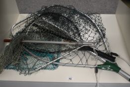 A selection of 3 landing nets of varying sizes and a small trawl or keep net