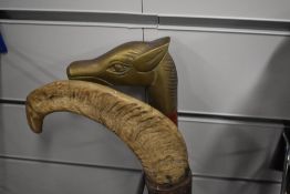 Two walking sticks measuring approximately 94cm long one with a brass dogs head and the other a rams