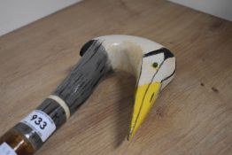 A wooden walking stick with the head carved and decorated in the form of a Heron a metal ferrule