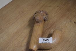 A decorative hazel shafted crook/walking stick, the terminal carved with rams head aside a thumb gr