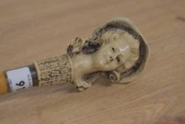 A cane walking stick with a carved head of a lady wearing a bonnet meaasuring 89cm long
