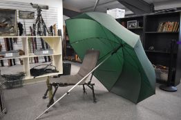 An on the bank seat together with a large umbrella and landing net