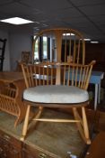 An Ercol light elm Windsor style rocking armchair with shaped tub-form back/arms, seat height 38cm