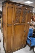 A 20th century oak hall robe, of panelled design with tracery motifs to single door, 174cm x 95cm