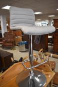 A modern chrome based bar stool, with foot rest and adjustable action, seat height 74cm