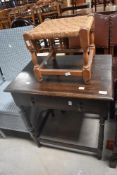 An early 20th Century oak occasional table and strung stool