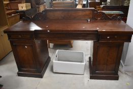 A 19th Century mahogany sideboard having ledge back frieze drawers on cupboard sections, width