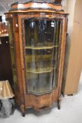 A 19th Century French Louis XIV style kingswood vitrine of narrow proportions , having shaped