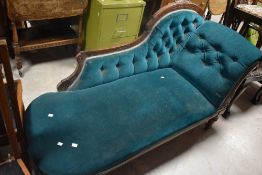 A late Victorian walnut framed chaise longue, of traditional design with deep buttoned padded '