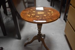 A vintage occasional pedestal table in the oriental style having circular top and triple splay legs,