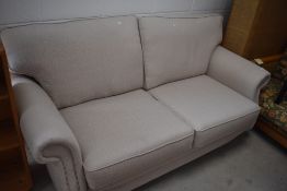 A modern two seater settee in nice clean condition with a neutral colour, width approx. 190cm