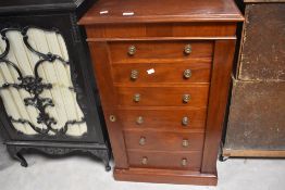 An interesting mahogany faux Wellington chest, the hinged door formed as a bank of lockable drawers,