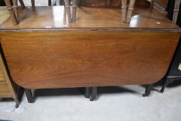 A George III mahogany drop-leaf dining table, of rectangular form the conforming leaves with rounded