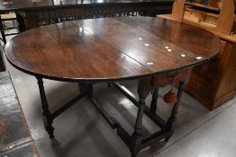 A 19th century oak drop-leaf gate-legged table, having demi-lune flaps and turned supports 70cm x