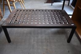 A stained frame coffee table, the top manufactured from a wooden screen