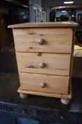 A modern pine bedside chest of three drawers, height approx. 59cm
