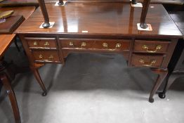 A late 19th/early 2oth century mahogany writing table, by Cooper & Holt (London) the moulded