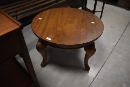A 20th century mahogany circular occasional table with four cabriole type supports 40cm x 63cm