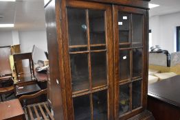 A 1940's oak bureau bookcase, of traditional form with glazed upper section over the fall front