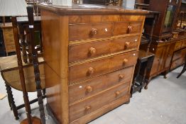 A Victorian mahogany chest of 2/4 graduating drawers, each with turned knob handles inset with