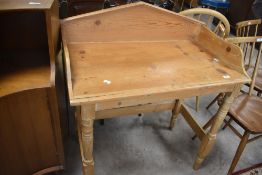 A reclaimed pine wash stand, having an architectural three quarter gallery and turned legs linked by