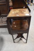 A Georgian mahogany washstand, of square section form with circular divisions over a mid drawer