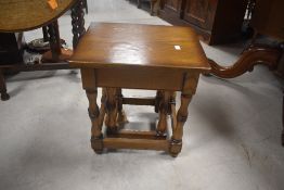 A modern oak nest of two occasional tables, of rectangular form with turned legs and plain