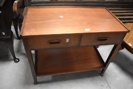 A 1970's teak two drawer trolley table, with under tier 62cm x 75cm x 40cm