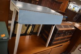 A 1950's formica topped drop-leaf table, with piano hinged leaves with locking sprung mechanism 74cm