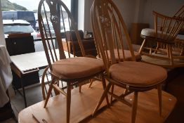 A set of six Ercol light elm Swan and spindle back dining chairs, of traditional design, seat height