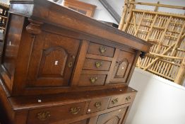 A 19th Century oak court cupboard having double cupboard and three central drawers to top