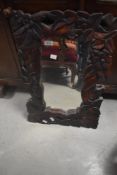 A modern carved wall mirror, approx. 59 x 40cm