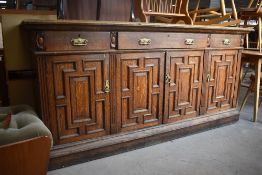 A Victorian oak sideboard having brass aesthetic style handles and cushioned style door fronts,