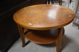 A vintage teak coffee table having circular top with carved cog style pattern, diameter approx.