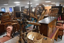 A traditional oak spinning wheel and assorted spinners utensils